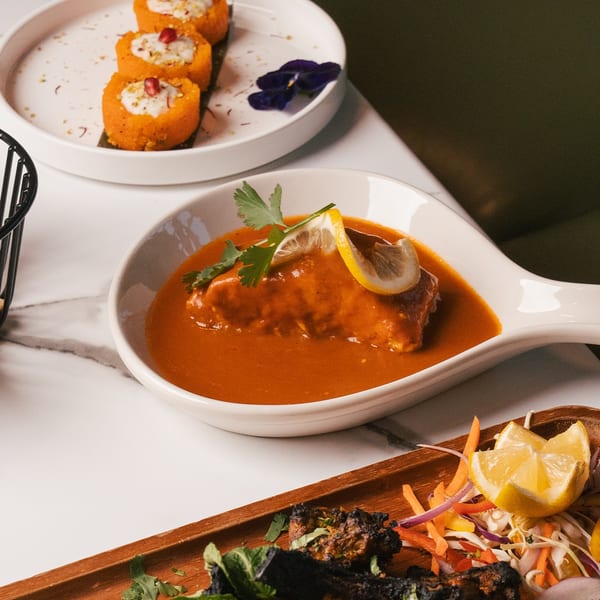 Three Indian dishes: sweet potato rolls, chicken curry, and grilled chicken with salad.